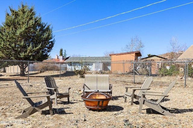 view of yard featuring fence and an outdoor fire pit