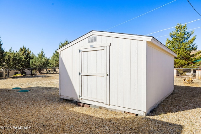 view of shed featuring fence