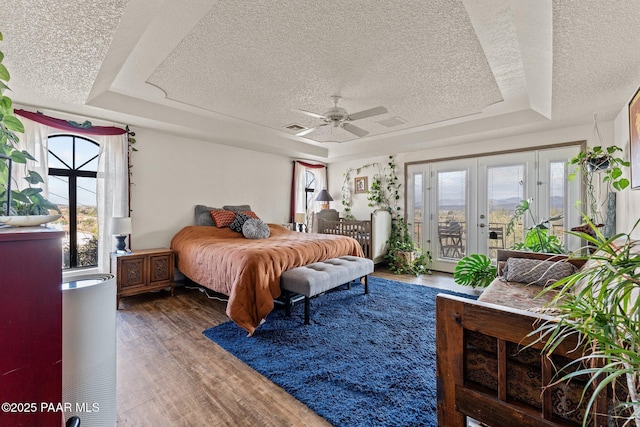 969 S Saguaro Dr, Wickenburg, AZ 85390 - bedroom featuring a raised ceiling, a textured ceiling, access to exterior, french doors, and wood finished floors