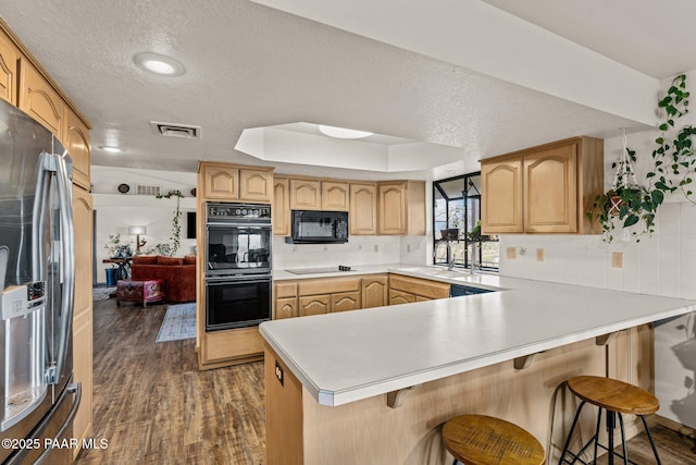 969 S Saguaro Dr, Wickenburg, AZ 85390 - kitchen featuring black appliances, a peninsula, backsplash, dark wood finished floors, and a textured ceiling