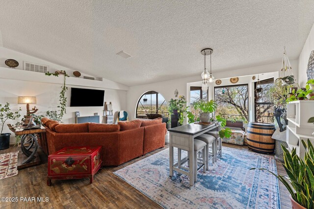 969 S Saguaro Dr, Wickenburg, AZ 85390 - living room featuring lofted ceiling, wood finished floors, and a textured ceiling