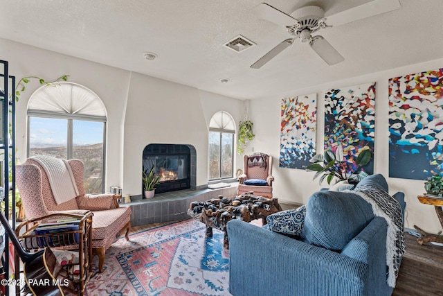 969 S Saguaro Dr, Wickenburg, AZ 85390 - living area featuring wood finished floors, a fireplace, and a ceiling fan