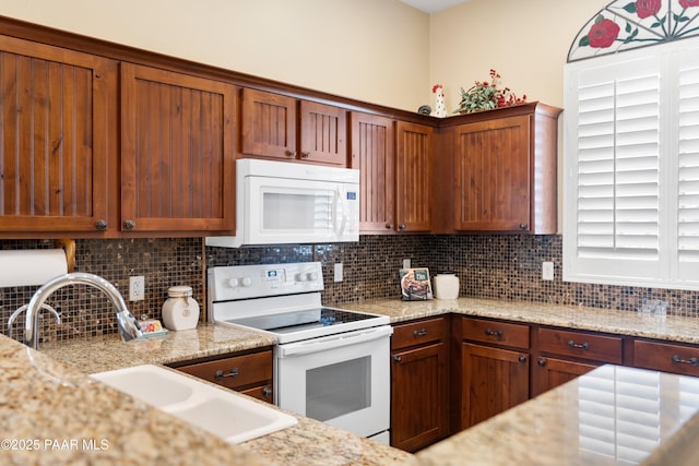 6237 E Boothwyn St, Prescott Valley, AZ 86314 - kitchen with white appliances, decorative backsplash, and light stone countertops
