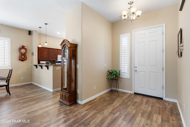 6237 E Boothwyn St, Prescott Valley, AZ 86314 - entrance foyer with wood finished floors, healthy amount of natural light, and a chandelier