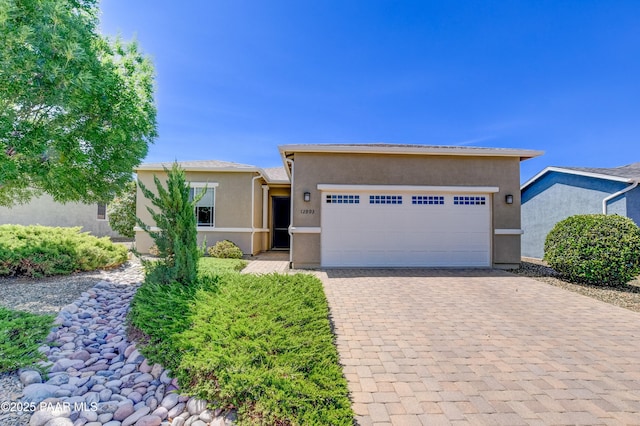 12993 E Toro St, Dewey-Humboldt, AZ 86327 - view of front facade with stucco siding, a garage, and decorative driveway