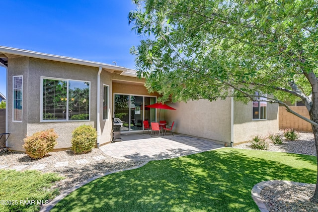 12993 E Toro St, Dewey-Humboldt, AZ 86327 - back of property with a patio area, stucco siding, and a lawn
