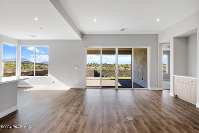 interior space with recessed lighting, visible vents, baseboards, and dark wood finished floors