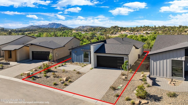 view of front of property featuring an attached garage, board and batten siding, and decorative driveway