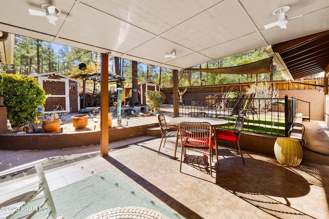 view of patio featuring ceiling fan and a storage shed