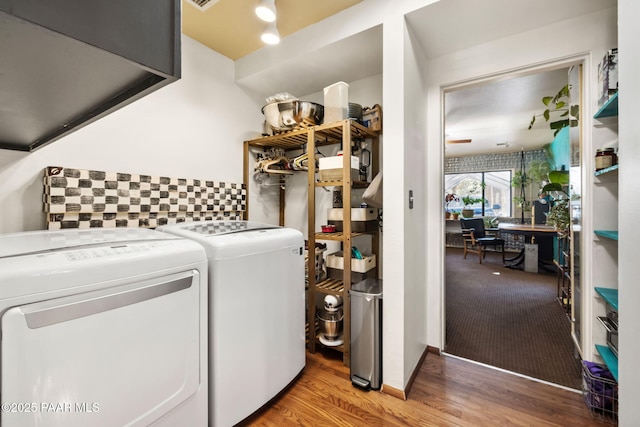 laundry room featuring ceiling fan, hardwood / wood-style floors, and separate washer and dryer