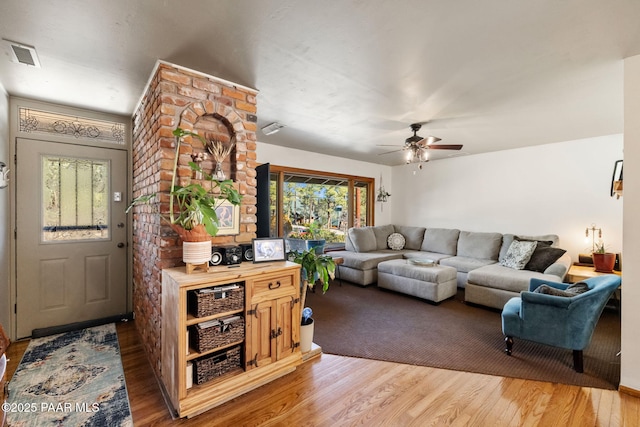 living room with ceiling fan and wood-type flooring