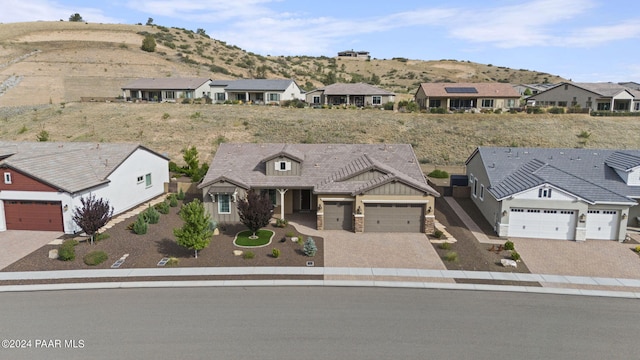 5109 Porter Creek Dr, Prescott, AZ 86301 - single story home with decorative driveway, an attached garage, a mountain view, and board and batten siding