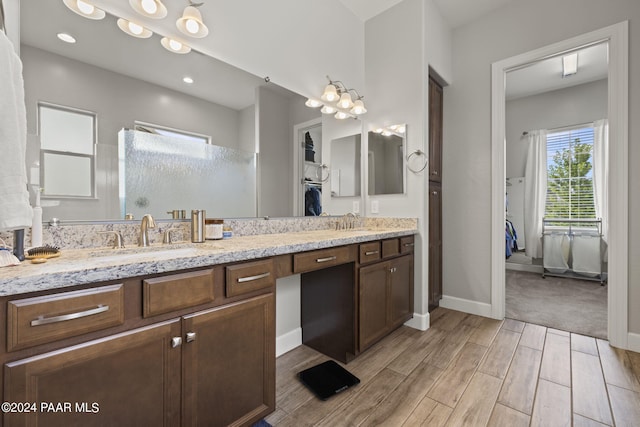 5109 Porter Creek Dr, Prescott, AZ 86301 - full bath featuring wood tiled floors, double vanity, a walk in shower, baseboards, and a walk in closet