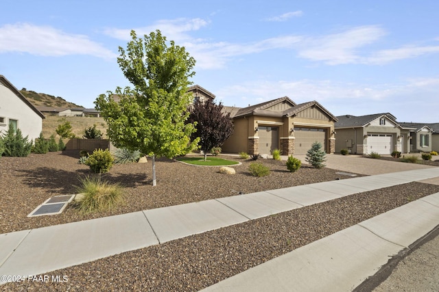 5109 Porter Creek Dr, Prescott, AZ 86301 - view of front of home featuring a garage, driveway, stone siding, board and batten siding, and a residential view