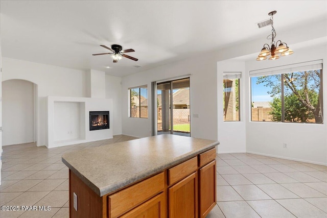 4786 N Edgemont Rd, Prescott Valley, AZ 86314 - kitchen with light tile patterned flooring, decorative light fixtures, ceiling fan, and a glass covered fireplace