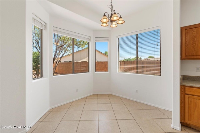 4786 N Edgemont Rd, Prescott Valley, AZ 86314 - unfurnished dining area with a chandelier and light tile patterned floors