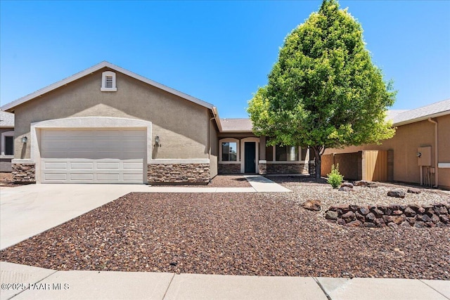 4786 N Edgemont Rd, Prescott Valley, AZ 86314 - view of front facade with stucco siding, driveway, a garage, and stone siding