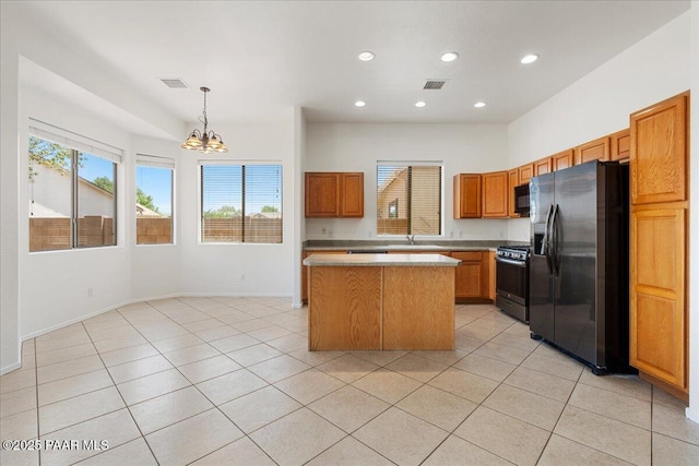 4786 N Edgemont Rd, Prescott Valley, AZ 86314 - kitchen with fridge with ice dispenser, stainless steel gas range, a chandelier, a center island, and light countertops