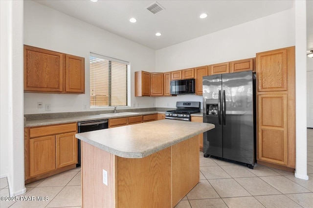 4786 N Edgemont Rd, Prescott Valley, AZ 86314 - kitchen featuring appliances with stainless steel finishes, light tile patterned floors, a kitchen island, recessed lighting, and light countertops