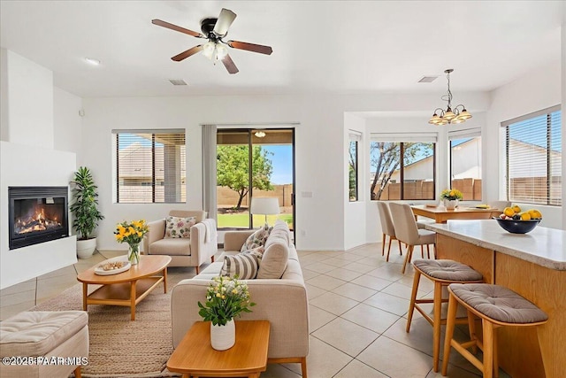 4786 N Edgemont Rd, Prescott Valley, AZ 86314 - living room with a chandelier, a glass covered fireplace, light tile patterned flooring, and a ceiling fan