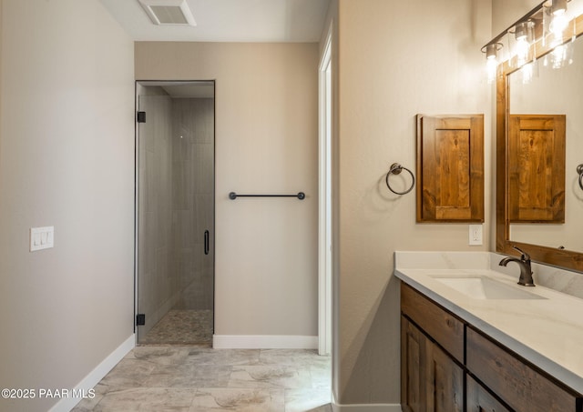 bathroom featuring vanity, baseboards, a stall shower, and marble finish flooring