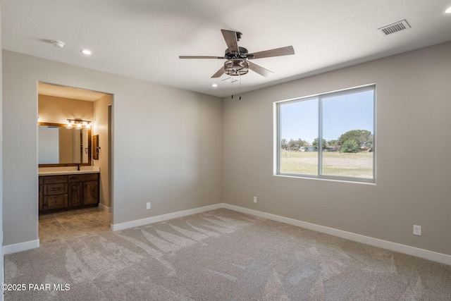 unfurnished bedroom with carpet floors, recessed lighting, baseboards, connected bathroom, and a sink