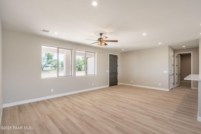 spare room with recessed lighting, a ceiling fan, light wood finished floors, and baseboards