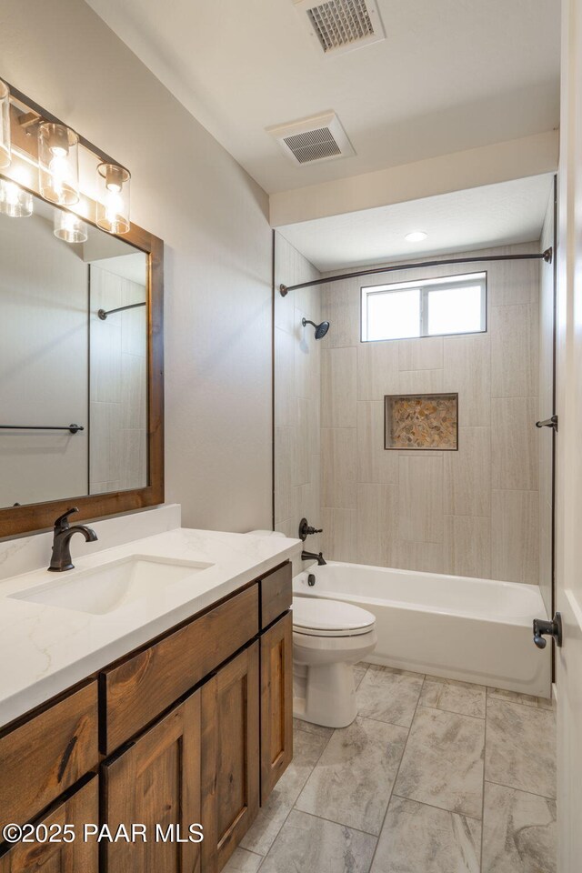 bathroom with vanity, toilet, and shower / bath combination