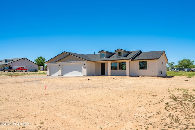 modern farmhouse featuring an attached garage and driveway