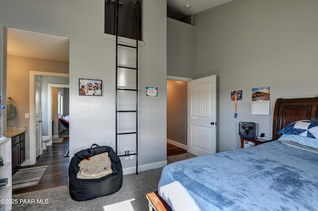 8675 N Buffalo Hill Ct, Prescott Valley, AZ 86315 - bedroom featuring baseboards, a towering ceiling, and dark carpet