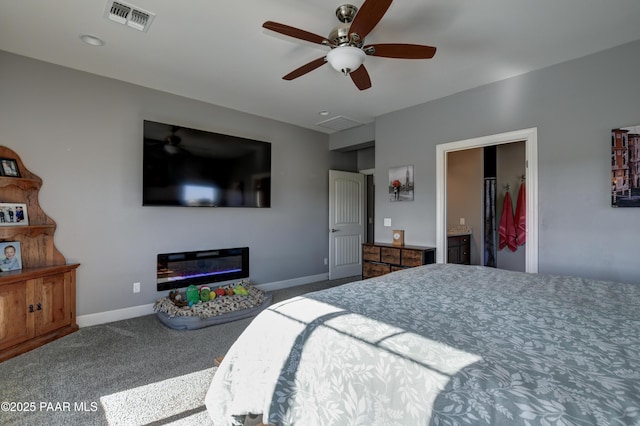 8675 N Buffalo Hill Ct, Prescott Valley, AZ 86315 - bedroom featuring carpet flooring, ceiling fan, a glass covered fireplace, baseboards, and visible vents