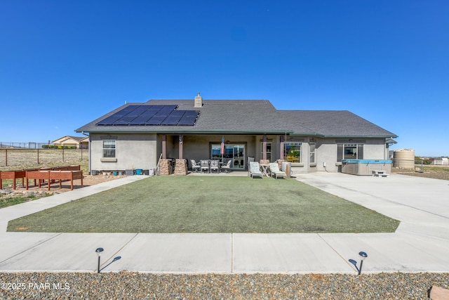 8675 N Buffalo Hill Ct, Prescott Valley, AZ 86315 - ranch-style home featuring fence, a shingled roof, stucco siding, solar panels, and a patio area