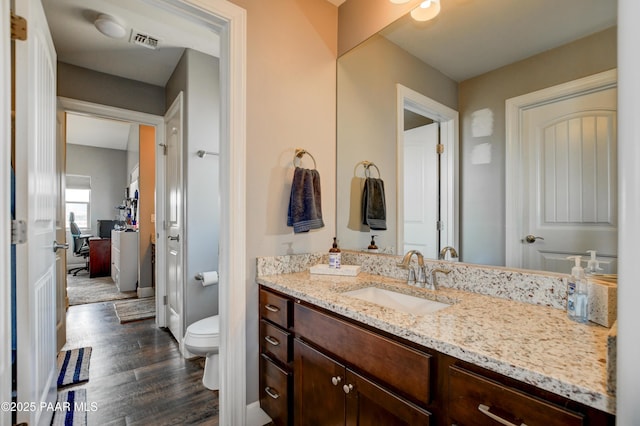 8675 N Buffalo Hill Ct, Prescott Valley, AZ 86315 - bathroom with visible vents, wood finished floors, toilet, and vanity