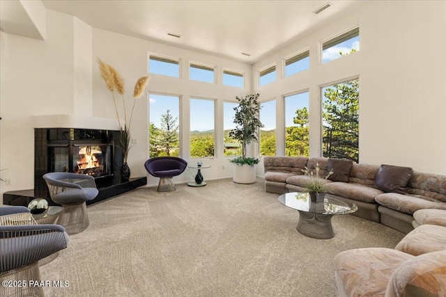 1369 Sierry Peaks Dr, Prescott, AZ 86305 - carpeted living area featuring a multi sided fireplace and a towering ceiling