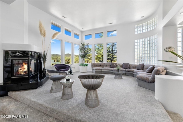 1369 Sierry Peaks Dr, Prescott, AZ 86305 - living area featuring carpet floors, a fireplace, and a high ceiling