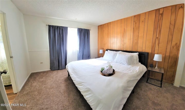 carpeted bedroom with wooden walls and a textured ceiling