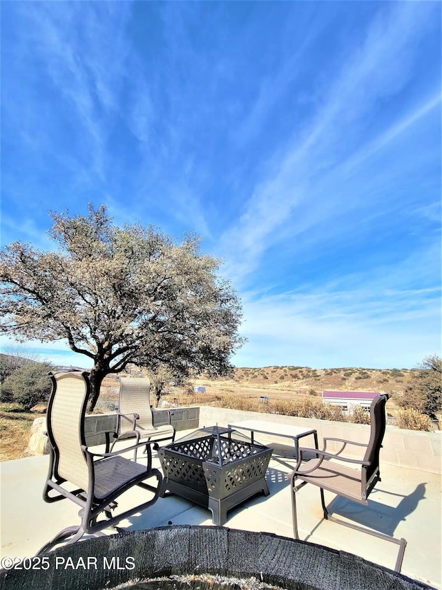 surrounding community featuring a patio and a fire pit