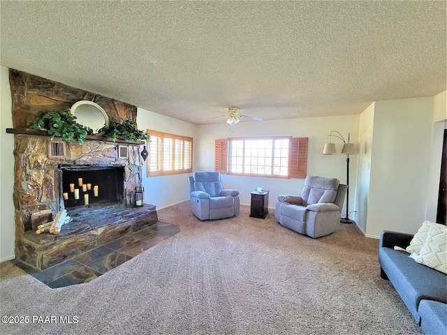 living room featuring a textured ceiling, a stone fireplace, carpet floors, visible vents, and a ceiling fan