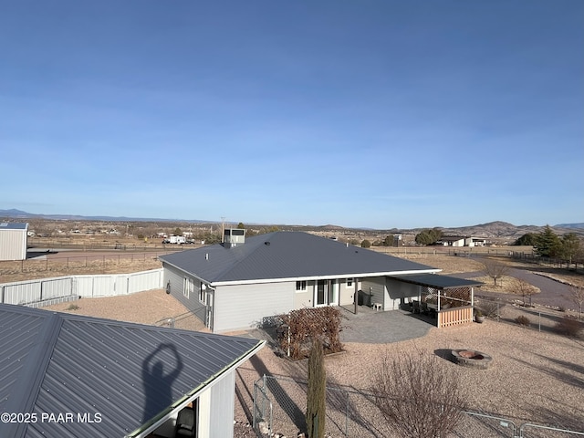 back of property with a mountain view