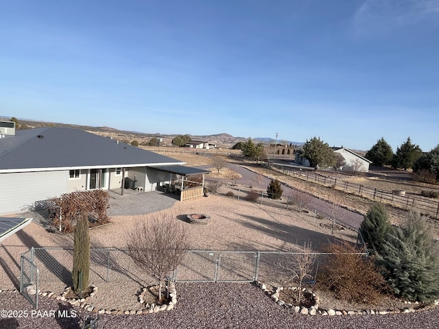 exterior space featuring an outdoor fire pit, a mountain view, and a patio area