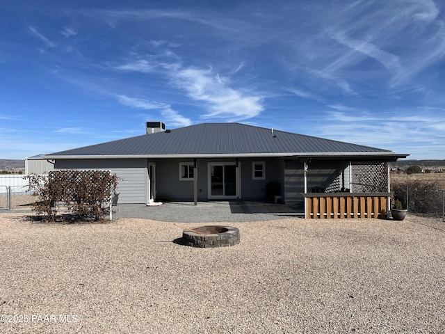 back of house featuring a patio and a fire pit