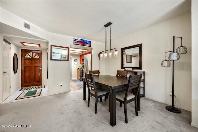 dining room featuring light colored carpet