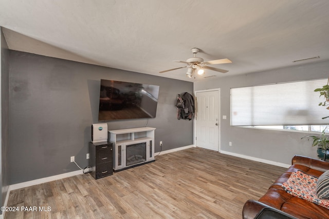 living room with hardwood / wood-style flooring and ceiling fan