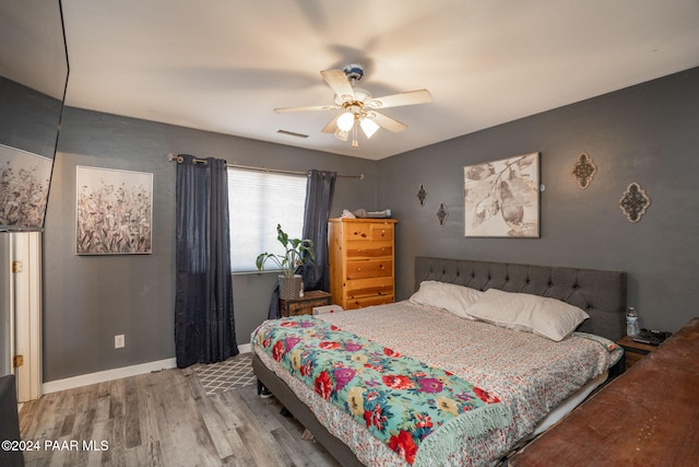 bedroom with hardwood / wood-style floors and ceiling fan