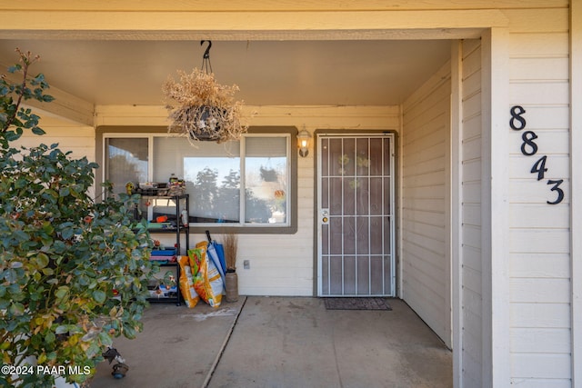 property entrance featuring a patio area