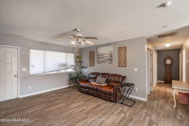 living room with hardwood / wood-style flooring and ceiling fan