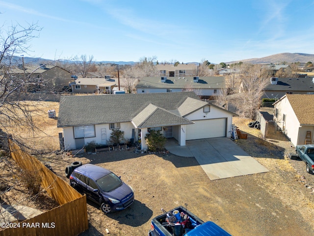 view of front facade with a mountain view and a garage