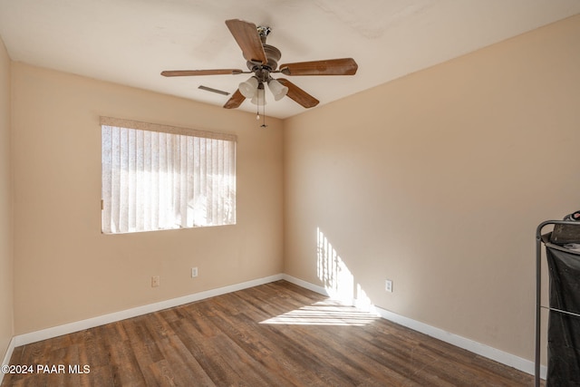 empty room featuring dark hardwood / wood-style floors and ceiling fan