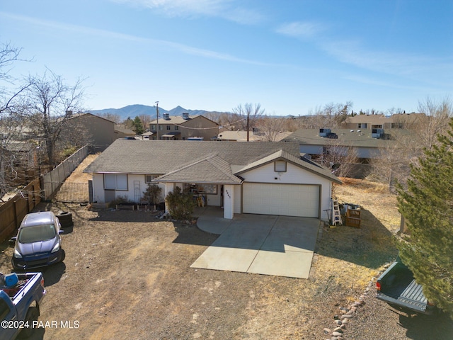 ranch-style house featuring a mountain view and a garage