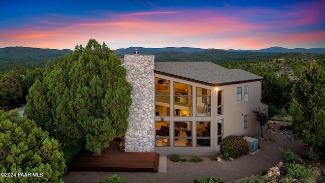 1301 S Manzanita Hill Rd, Prescott, AZ 86303 - back of property at dusk with a mountain view and a chimney